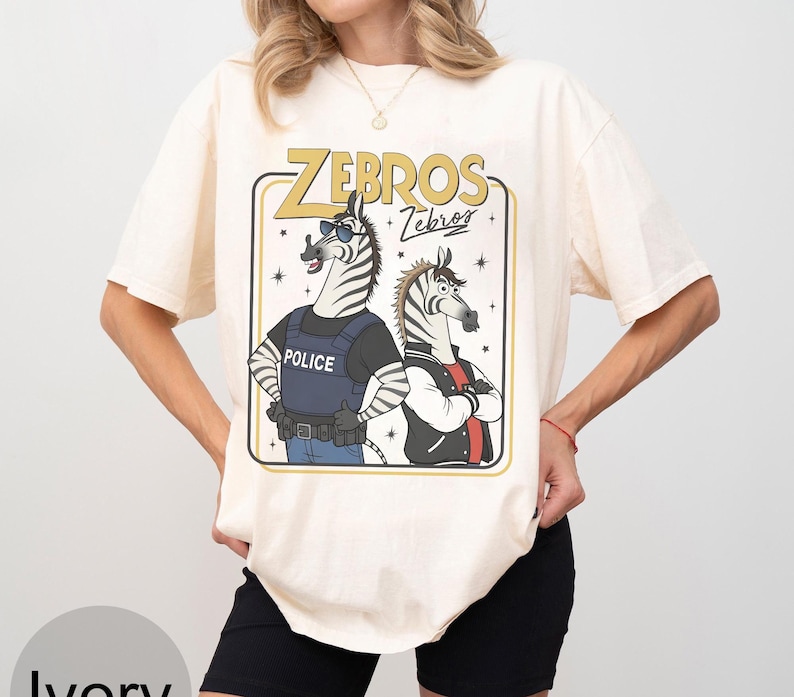 May include: A white ceramic mug with a black handle and the text "But First, Coffee" in a bold, black font. The mug is set against a blurred background, suggesting a cozy setting.