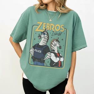 May include: A set of three ceramic mugs with a speckled, matte finish. The mugs are in shades of cream, light gray, and dark gray. Each mug has a simple, minimalist design, perfect for coffee or tea.