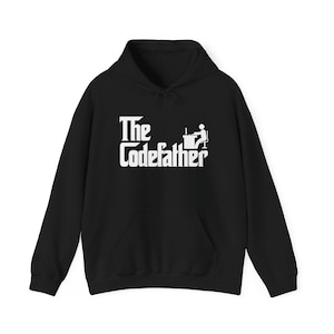 May include: Black hoodie featuring the text "The Codefather" in white, with a programmer icon. The sweatshirt has a front pocket and a drawstring hood. A casual, comfortable garment.