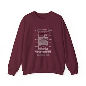 May include: A maroon long-sleeve sweatshirt featuring white text and mathematical diagrams. The graphic displays the text NO FORMULA FOR THE QUINTIC, algebraic equations, and the statement THE ROOTS EXIST. THE FORMULA DOES NOT.