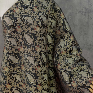 May include: A black fabric featuring a repeating pattern of gold and muted green stylized leaves and rounded floral shapes. The intricate design is arranged in a grid-like layout with thin gold outlines surrounding each individual motif.