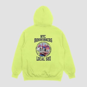Puede incluir: Una sudadera con capucha de color amarillo brillante con un logotipo en blanco y negro en la parte posterior. El logotipo dice "NYC Ironworkers International Association of Bridge, Structural, Ornamental and Reinforcing Iron Workers Local 580".