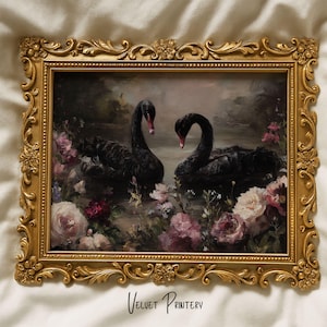May include: A framed print featuring two black swans with red beaks, floating in water amidst pink and white flowers. The artwork is set within an ornate gold-colored frame. The text "Velvet Printery" is at the bottom.
