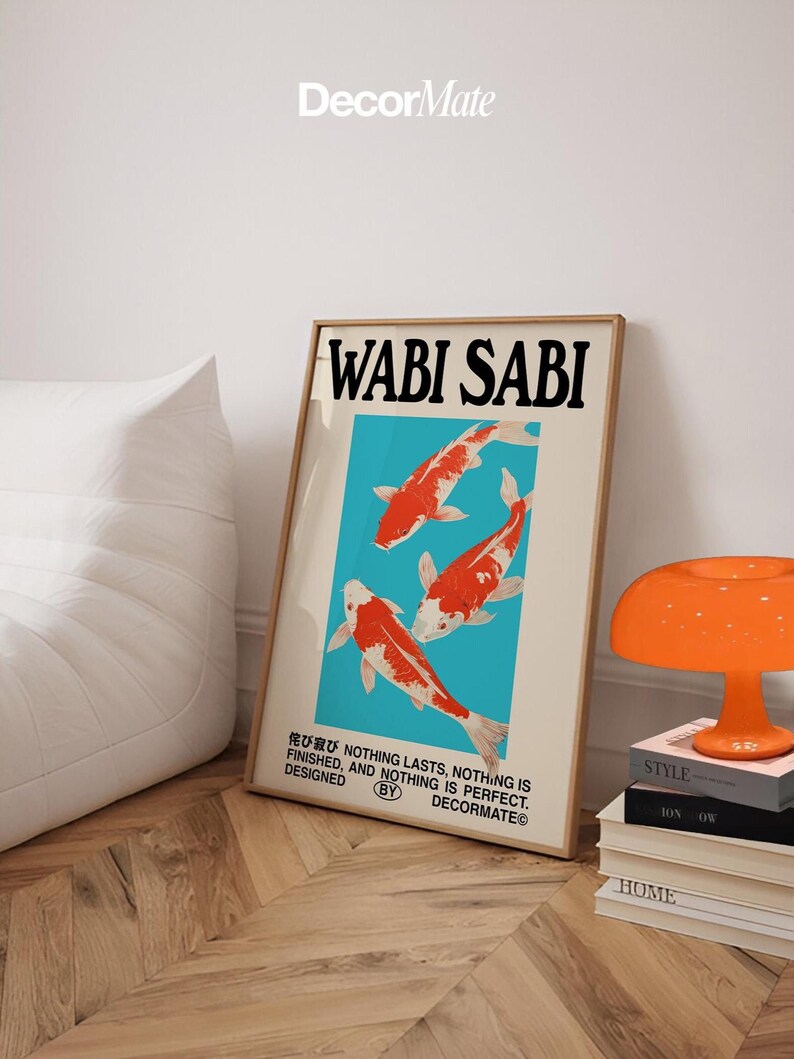 May include: A framed art print with the words "WABI SABI" in bold black letters. The artwork features three orange and white koi fish against a teal background. The print also includes Japanese text and the phrase "NOTHING LASTS, NOTHING IS FINISHED, AND NOTHING IS PERFECT."