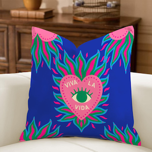 May include: A square blue decorative pillow with a pink heart-shaped design in the center. The heart contains an eye and the words "VIVA LA VIDA". The design is surrounded by pink, green, and blue flame-like shapes.