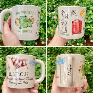 May include: Four ceramic mugs with various designs. One mug features a frog lifting weights with the text "NO SQUATS NO BOOTY". Another has a chef mouse and a red suitcase. One mug has the text "B.I.T.C.H". The last mug has the name "&Alpha;&lambda;&epsilon;&xi;ί&alpha;".