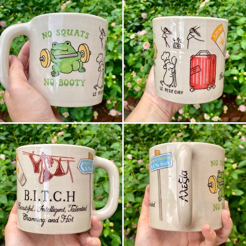 May include: Four ceramic mugs with various designs. One mug features a frog lifting weights with the text "NO SQUATS NO BOOTY". Another has a chef mouse and a red suitcase. One mug has the text "B.I.T.C.H". The last mug has the name "&Alpha;&lambda;&epsilon;&xi;ί&alpha;".