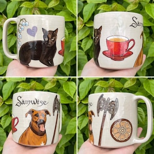 May include: Four ceramic mugs with unique hand-painted designs. One mug features a black cat, another a red teacup, and two depict a dog with an axe. Each mug has a cream-colored base and a large handle.