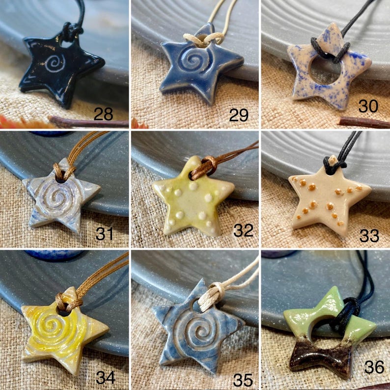 May include: A selection of star-shaped ceramic pendants in various colours, each with a unique design and cord. The pendants include shades of blue, yellow, and cream, with spiral or dot patterns. Numbers 28-36 are visible.