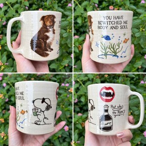May include: Four ceramic mugs with unique designs. One mug features a dog illustration, another has the text "You have bewitched me body and soul", a third has a Snoopy illustration, and the last has a vampire mouth and a rum bottle.