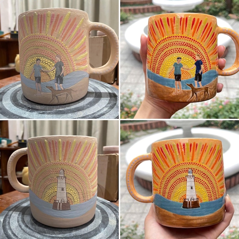 May include: Hand-painted ceramic mug featuring a sunset design with two figures and a dog on a beach. The mug has a large handle and is painted with orange, yellow, and blue hues. The design is repeated on the other side of the mug, but with a lighthouse.