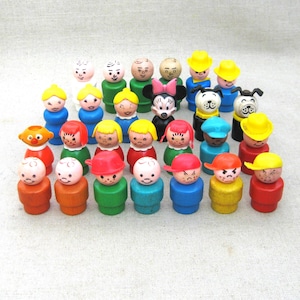 May include: A collection of vintage wooden toy figures with painted faces, hats, and clothing. The figures are in various colors, including red, yellow, blue, and green. Some figures have animal faces, and one has a Minnie Mouse design.