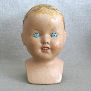 Terrific Vintage Composite Doll Head with Shoulder Yoke. Bright Blue Painted Wooden Eyes. Perfect for all kinds of uses, from adding to a collection, to Halloween décor, or as Doll Parts and Supplies for Doll Repair to Assemblage Sculpture. Listing is for 1 doll head, other props are NOT included.