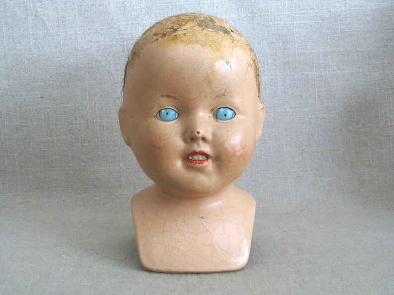 Terrific Vintage Composite Doll Head with Shoulder Yoke. Bright Blue Painted Wooden Eyes. Perfect for all kinds of uses, from adding to a collection, to Halloween décor, or as Doll Parts and Supplies for Doll Repair to Assemblage Sculpture. Listing is for 1 doll head, other props are NOT included.