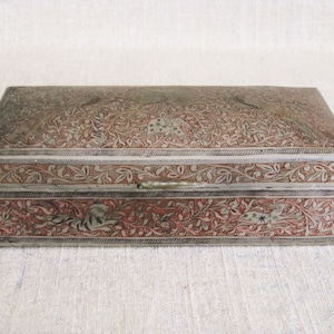 Delightful Vintage, Antique Metal Trinket Box w wood liner. All Over, etched surface w Animal motif. Peacocks grace lid, w mix of other wild life including Elephants, Tigers and Gazelles. Brass box w silver plate finish, red rubbed inlay.