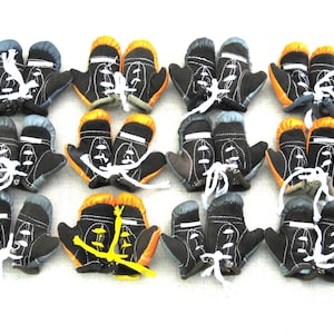 May include: Twelve pairs of miniature boxing gloves, each pair featuring a different color combination. The gloves are made of black, gray, and orange fabric with white laces.