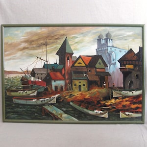May include: An oil painting of a coastal village with boats and buildings. The artwork features a variety of colors, including red, blue, and brown, and is framed in a green wooden frame. The painting depicts a harbor scene with boats and buildings.