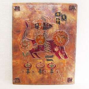 Terrific Embossed Vintage Copper Relief Panel. This Animal Art piece depicts a Lion, heavily surrounded by all kinds of intricate details, and symbolism. Mounted to a wooden panel with a wooden frame on the backside for depth and stability.