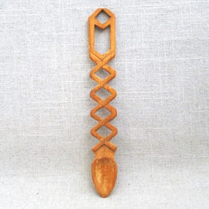 Hand Carved Wooden Spoon. Folk Art Spoon, often referred to as Loving Spoons: A wooden spoon,  carved by a Welsh suitor as an engagement gift for his promised bride. Delightful Intertwined Design. Signed w initials, FR, dated 1994 on bottom of bowl.