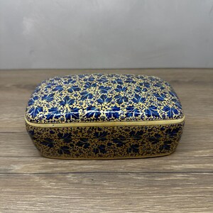 May include: A rectangular lidded box featuring a dense, intricate pattern of deep blue maple-like leaves set against a vibrant gold background. The design covers the entire exterior surface, including the lid and the base, with a smooth finish.
