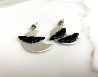 Pearlescent Moon with Black Twinkle Bats Dangling from Rhodium Plated Studs | Asymmetrical Polymer Clay Halloween Earrings