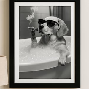 May include: Black and white framed print of a dog in a bathtub, wearing sunglasses and smoking a cigar. The dog is surrounded by bubbles, creating a humorous and relaxed scene. The image is a grayscale photograph.