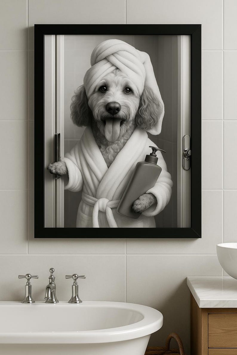 May include: Black and white framed print of a dog in a spa setting. The dog is wearing a white robe and towel, holding a bottle of soap. The dog is sticking its tongue out. The print is hanging in a bathroom with a white tub.