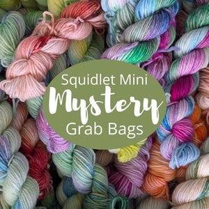 May include: A collection of multi-colored yarn skeins in various pastel and vibrant hues, including pink, blue, green, and orange. An olive green oval overlay in the center features the white text Squidlet Mini Mystery Grab Bags.