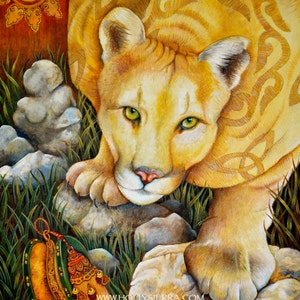May include: A detailed painting of a cougar with yellow fur and green eyes, resting on rocks amidst green grass. The cougar has Celtic knotwork patterns on its back. A decorative item with tassels and beads is in the foreground. The sun is in the upper left corner.