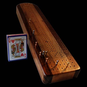 Deluxe Hardwood Cribbage Board with laser graphics depicting all the numeral and line sections with silhouettes of skunk and double skunk.