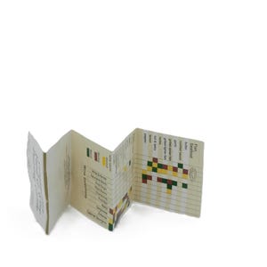 May include: A folded paper wine and food pairing guide. The guide is cream-colored with black text and colorful pixelated graphics. The guide lists wine selections and seafood options with suggested pairings.