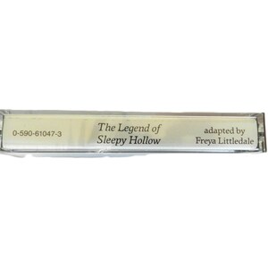 May include: A clear plastic cassette tape case with the text "The Legend of Sleepy Hollow" and "adapted by Freya Littledale" printed on a white label. The case also has the number "0-590-61047-3" printed on it.