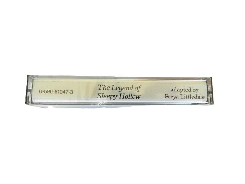 May include: A clear plastic cassette tape case with the text "The Legend of Sleepy Hollow" and "adapted by Freya Littledale" printed on a white label. The case also has the number "0-590-61047-3" printed on it.