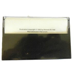 May include: A black cassette tape case with a white label that reads "Illustration copyright &copy; 1992 by Melanie W. Hall. Manufactured in the U.S.A."
