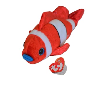 May include: A red and white striped plush clownfish with a blue mouth and a Ty Beanie Babies tag.