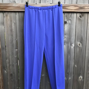 This is a pair of  Vera Neumann blue pleated pants produced by Gertrude Davenport Inc.  The tag reads 16 but measures about 42.5 inches long from waist band to hem, inseam to hem about 29.5 inches long, waist band to inseam about 14.5 inches long,