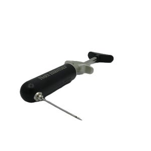 May include: A black and silver wine preserver tool with a needle and a handle. The tool has the text "NAPA ESSENTIALS" printed on the black barrel. The handle is black and the needle is silver.