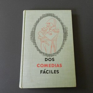 May include: A green book with a black and white illustration of a man in a military uniform. The title of the book is "DOS COMEDIAS FÁCILES" in red and black text.