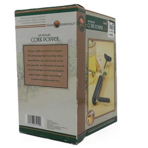 May include: A box for a Napa Essentials Air Pressure Cork Popper. The box is beige and green with text that reads "Air Pressure Cork Popper". The box also has an image of the cork popper and a wine bottle.