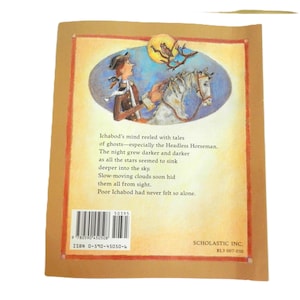 May include: A brown book cover with a picture of a man riding a horse in front of a dark sky with stars. The text on the cover reads "Ichabod's mind reeled with tales of ghosts-especially the Headless Horseman. The night grew darker and darker as all the stars seemed to sink deeper into the sky. Slow-moving clouds soon hid them all from sight. Poor Ichabod had never felt so alone."