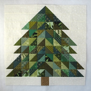 May include: A green and brown patchwork quilt in the shape of a Christmas tree. The tree is made up of many different fabric squares and triangles, each with a unique pattern.