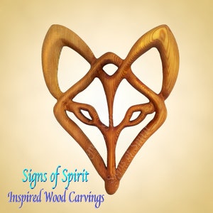 May include: A wooden carving of a fox's head, with intricate details and a knotwork design. The carving is made of light brown wood and has a natural finish. The carving is a unique and beautiful piece of art that would make a great addition to any home.