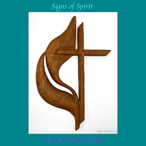 May include: A wooden carving depicting a flame and cross, a symbol of the Holy Spirit. The carving is brown and has a natural wood finish. It is a religious art piece.