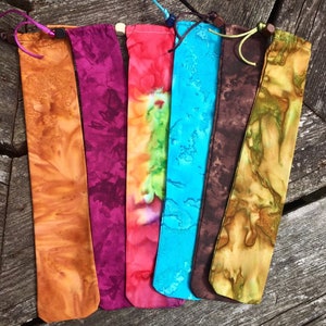 May include: Six fabric pouches with tie closures in various tie-dye patterns, including orange, purple, red, blue, brown, and green.