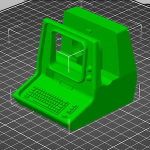 May include: A vibrant green 3D-printed model of a retro computer. It has a keyboard, screen, and a boxy design, similar to old arcade machines. The object is set against a grid background.