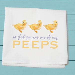 May include: White kitchen towel with three yellow ducklings and the text "so glad you are one of my PEEPS" in purple and yellow.