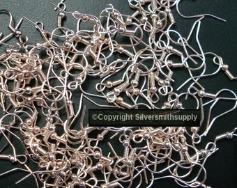 May include: A pile of silver-toned earring hooks with a spring-loaded closure. The hooks are made of metal and have a small ball at the top.