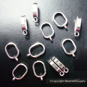 May include: Ten silver-toned metal pendant bails with a rectangular opening. The bails have a loop at the top for attaching to a chain or cord.