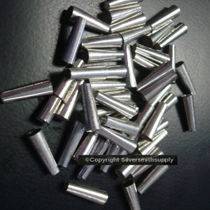 May include: A pile of silver-colored metal tubes, likely used for jewelry making. The tubes are tapered and have a shiny finish.  ©Copyright Silversmithsupply