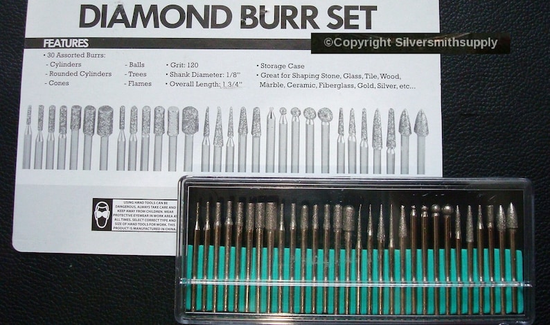 May include: A set of 30 diamond burrs in a clear plastic case. The burrs are assorted shapes, including balls, cones, cylinders, and flames. The burrs are 1/8 inch in diameter and 1 3/4 inches long. The burrs are grit 120 and are great for shaping stone, glass, tile, wood, marble, ceramic, fiberglass, gold, silver, and more.